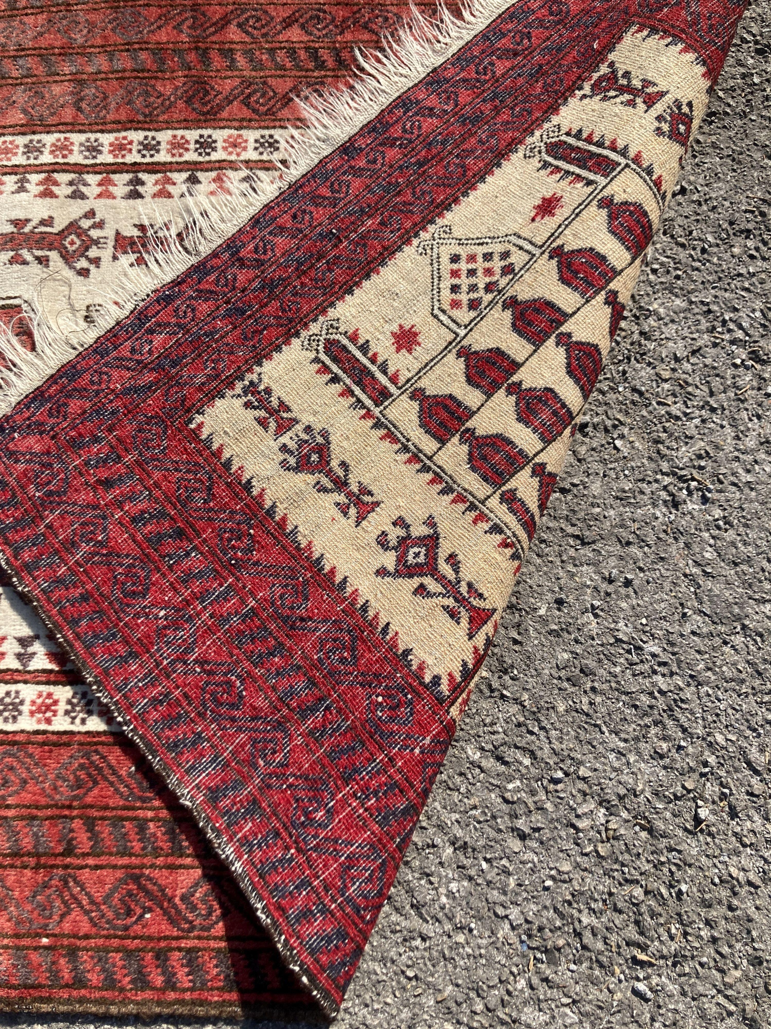 A Persian ivory ground rug, with geometric field, 150 x 91cm